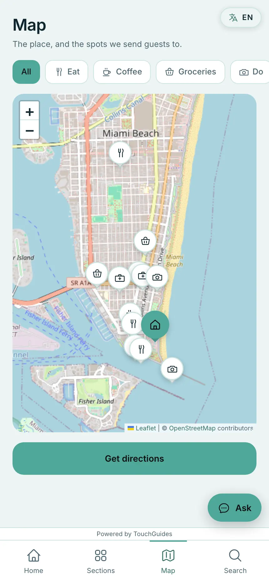 The map in a guest guidebook: the property pinned among the host's recommendations, filtered by category, with a directions button under it